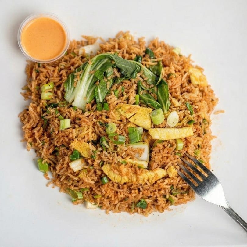 Fried rice with bok choy, scrambled egg, green onions, and a side of orange sauce.